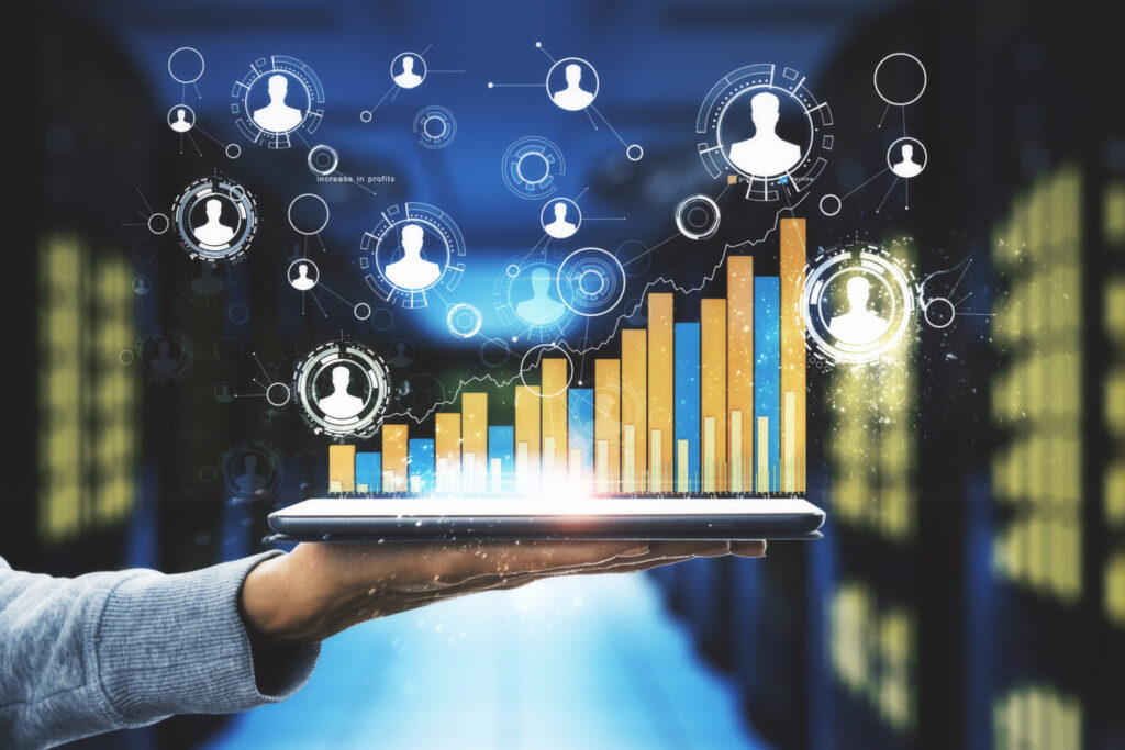 A hand holding a tablet that projects a glowing digital bar chart showing upward growth, connected to a floating network of user profile icons.